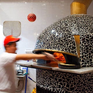 Forcella; New York City Known for his specialty, flash-fried then oven-fired pizzas crusts, Forcella chef-owner Giulio Adriani uses Neapolitan Acunto ovens at his Williamsburg and East Village locations. He decorated them himself with hand-cracked black tiles. Oven maker Mario Acunto sells his ovens at whatever price he feels is right for the buyer. "He doesn't care about selling the oven," Adriani says. "In Napoli they call him Mario <i>matto</i> — Mario the crazy guy." Must try: The Montanara, a Margherita with a fried crust that's finished in the oven.
<br /><br />
<a href="forcellaeatery.com" target="_blank">forcellaeatery.com</a>