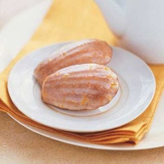 <p>These shell-shaped, cakey cookies are a French treat typically served with tea. The buttery madeleines are spiced with ground cardamom and coated with a sweet citrus icing.</p><p><b>Recipe: <a href="http://gogonow.org/recipefinder/orange-cardamom-madeleines-recipe%22 target="_blank">Orange-Cardamom Madeleines</a></b></p>