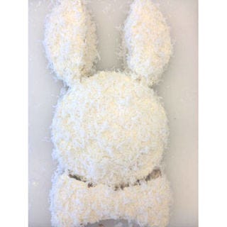 <p>Using store bought buttercream (or <a href="http://www.goodhousekeeping.com/recipefinder/silver-white-cake-buttercream-recipe-ghk0510" target="_blank">this recipe</a> for a homemade version) frost all parts of the cake following the directions on the jar. Sprinkle coconut all over the cake, pressing it into the frosting so it sticks.</p>