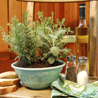 For a year-round centerpiece that pulls its weight in the kitchen, plant a large bowl with assorted herbs. Pick plants that have the same sun and water requirements, since they'll be roommates, so to speak. Pinch off a few leaves as you're cooking for a fresh-tasting boost of flavor to your dish. Great herbs to try include basil, thyme, rosemary, and parsley.