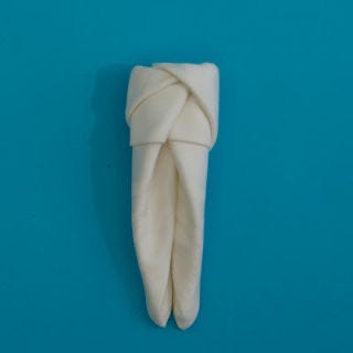 Fold the right side over, tucking the end into the pocket you created on the left side, holding your napkin together.