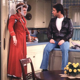 <p>Bright and sunny, the Cunninghams' pass-through kitchen reflected mom Marion's flighty personality. Her kitchen featured matchy-match decor, blue plaid wallpaper, cornflower blue countertops, and frilly curtains. Throw in linoleum flooring and it was a state-of-the-art 1950s kitchen.</p><br /><p><a href="http://www.bing.com/videos/search?q=Happy+Days+theme&view=detail&mid=C340BFE244335FB8BA76C340BFE244335FB8BA76&first=0&FORM=delish" target="_blank">Watch the opening theme</a></p><br /><p><a href="http://www.bing.com/videos/search?q=%22happy+days%22+filterui%3aduration-short&view=detail&mid=0242D1570F12AFBFD96D0242D1570F12AFBFD96D&first=41&FORM=delish" target="_blank">Do the Fonzie</a></p><br /><p><a href="http://www.bing.com/videos/search?q=%22happy+days%22+marion&view=detail&mid=C0776416E491139B4716C0776416E491139B4716&first=0&FORM=delish" target="_blank">Watch an interview with Marion Ross</a></p><br /><p><a href="http://www.bing.com/videos/search?q=full+episodes+happy+days&go=&qs=n&sk=&sc=1-24&form=QBVR" target="_blank">Watch full episodes</a></p><br /><p><a href="http://www.bing.com/images/search?q=%22happy+days%22+house&qpvt=%22happy+days%22+house&FORM=delish" target="_blank">Photos of the "Happy Days" house</a></p>
