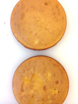 <p>Prepare cake according to the directions on the box. Split the batter evenly between two cake pans and bake as directed. Let cool completely. Check out our <a href="http://www.goodhousekeeping.com/product-reviews/food-products/cake-mix-reviews/best-yellow-cake-mixes" target="_blank">cake mix reviews</a> or try this simple <a href="http://www.goodhousekeeping.com/recipefinder/basic-butter-cake-2249" target="_blank">scratch cake recipe</a>.</p>