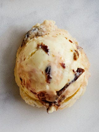 <p>Soak 1 1/2 cups finely chopped dried figs in 1 cup Armagnac brandy for 1 hour; drain. Swirl figs, 3/4 cup butterscotch caramel sauce, and 1/2 teaspoon sea salt into prepared gelato before freezing in step 3.</p>