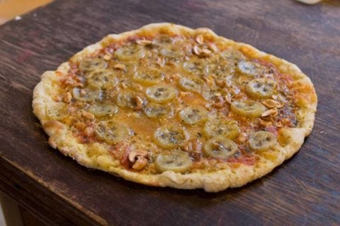 <p>With a mixture of sweet, salty, and spicy, the popular banana curry pizza made with a <a href="http://andmykitchensink.com/banana-curry-pizza-a-swedish-favorite/" target="_blank">smoky ham, smokier cheese, curry powder, and ripe bananas</a> is a Swedish favorite. In fact, it's become so trendy in recent years that even a <a href="http://www.bloomberg.com/news/2013-08-08/new-york-hot-restaurants-serve-banana-curry-fried-pizza.html" target="_blank">few pizzerias in New York City</a> have started to serve it.</p>