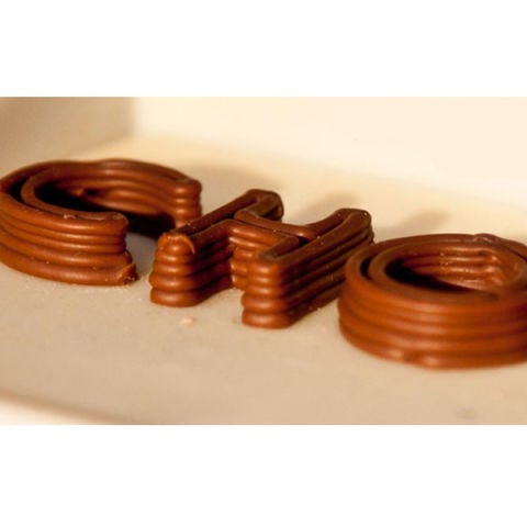 U.K.-based company <a href="https://chocedge.com/index.php" target="_blank">ChocEdge</a> specializes in a machine that makes only chocolate-based creations, like these letters. (Can you guess what they're starting to spell?) The Choc Creator V1 printer retails at nearly £3,000, but for professional chocolatiers and food business owners, it may be well worth the investment.