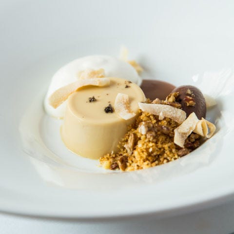 <p><strong>Blonde chocolate panna cotta, $11</strong><br /><span>Inspired by her mother's German chocolate–peanut butter cake, chef Kelly Fields aimed to create a dessert with the same buttery-salty-sweet profile for her menu at John Besh's flagship. To intensify the silky panna cotta, she uses Valrhona's Dulcey blonde chocolate. "The way it's processed and caramelized with French dairy really brings out the salty notes," Fields says. "It is my favorite quality of this chocolate." Accents of toasted coconut ribbons, dark chocolate, crushed pecans and vanilla sea salt complete this beautifully composed dish.</span><em><a title="Restaurant August" href="http://www.restaurantaugust.com/" target="_blank">restaurantaugust.com</a></em></p>