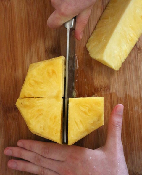 <p>Rotate the knife 90 degrees and cut through the center again, resulting in four even pineapple pieces. </p>