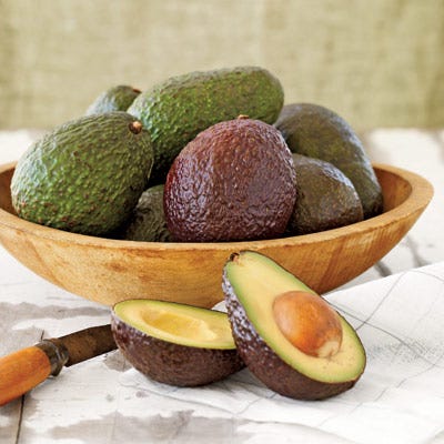 The pebbled green skin of California-grown Hass avocados ripens to a deep purple.