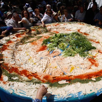 <p><b>Record holder: Hummus Tzabar</b></p>

<p>Location: Jerusalem, Israel</p>

<p>May 8, 2008</p>

<p>Garlic breath be darned, market-goers at the Mahaneh Yehuda market in Jerusalem tucked into more than 1,000 tons of lemony chickpea dip from the largest single plate of hummus on Israeli Independence Day ("Yom Haatzmaut") 2008. We're really hoping no one double-dipped.</p>

