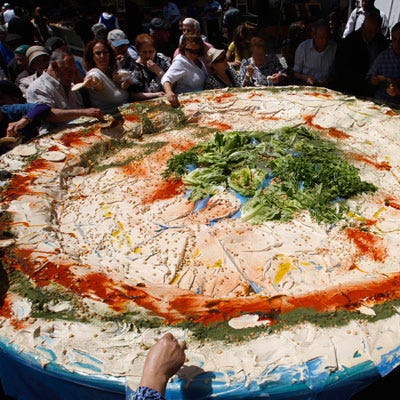 <p><b>Record holder: Hummus Tzabar</b></p>

<p>Location: Jerusalem, Israel</p>

<p>May 8, 2008</p>

<p>Garlic breath be darned, market-goers at the Mahaneh Yehuda market in Jerusalem tucked into more than 1,000 tons of lemony chickpea dip from the largest single plate of hummus on Israeli Independence Day ("Yom Haatzmaut") 2008. We're really hoping no one double-dipped.</p>

