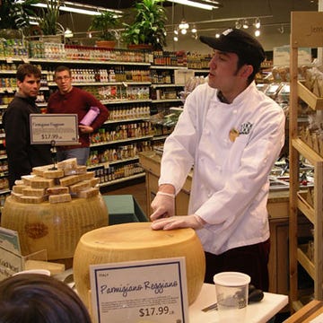 A cheesemonger at a Whole Foods Market participated in the simultaneous cracking of almost 300 wheels of Parmigiano-Reggiano.