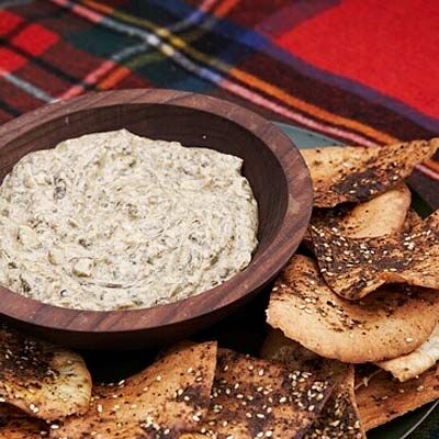 <p>Creamy and slightly spicy, this dip can be reheated to taste, but it is also delightful at room temperature. White wine, marinated artichokes, garlic, and cheese add depth and fragrance. </p><br /><p><b>Recipe: </b><a href="/recipefinder/artichoke-spinach-dip-spiced-pita-chips-recipe" target="_blank"><b>Artichoke-and-Spinach Dip with Spiced Pita Chips</b></a></p>