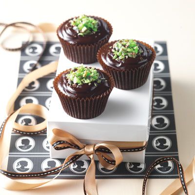 <p>Spread the top of each cake generously with dark chocolate ganache. Top each cake with crushed mint chocolate candies.</p>