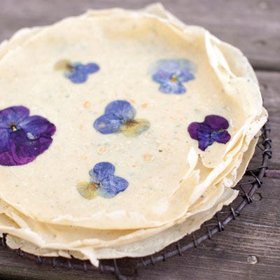 <p>"Spring, summer, and fall, pansies decorate my pancake plates. These pancakes are really crepes, so the batter can be made the night before — give it a gentle shake in the morning, and it's ready to go. It's fun to see a little flower peeking up at you from the plate. Served with a floral syrup, it is a great way to wake up in the morning." — Miche Bacher</p>
<p><strong>Recipe:</strong> <a href="../../../recipefinder/pansy-petal-pancakes-recipe-del0313" target="_blank"><strong>Pansy Petal Pancakes</strong></a></p>