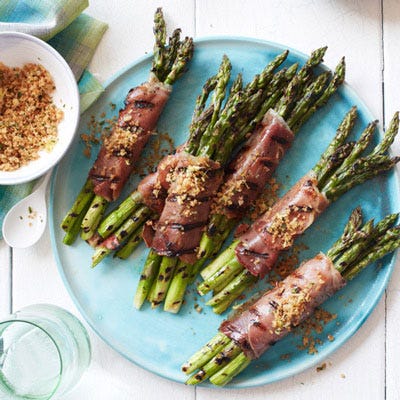 <p>Michael Chiarello cooks these asparagus twice: The first time early in the grilling session; the second time right before serving, after they're wrapped in prosciutto.</p><p><b>Recipe: </b><a href="http://gogonow.org/recipefinder/prosciutto-wrapped-asparagus-lemony-bread-crumbs-recipe-fw0613%22 target="_blank"><b>Prosciutto-Wrapped Asparagus with Lemony Bread Crumbs</b></a></p>