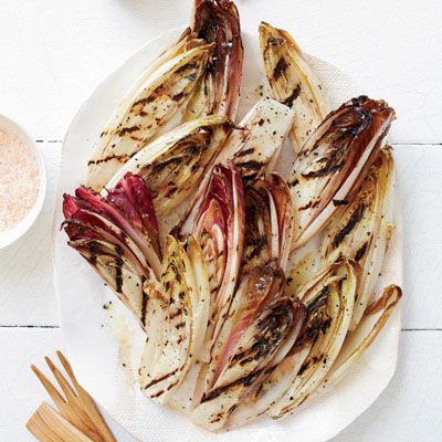 <p>In this incredibly easy recipe, Michael Chiarello brushes endives with olive oil, grills them until lightly charred and super-juicy, then dresses them with olive oil. The endives can be grilled while the roast is just starting to cook, then set aside, since they're terrific at room temperature or chilled.</p><p><b>Recipe: </b><a href="http://www.delish.com/recipefinder/charred-smoky-belgian-endives-recipe-fw0613" target="_blank"><b>Charred and Smoky Belgian Endives </b></a></p>