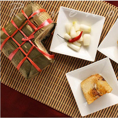 Vietnam: Bahn Chung <p>One of the most important foods consumed during New Year's (or Tết) celebrations in Vietnam, <i>bahn chung</i> is a large rice cake, with layers of pork, mung bean, and other ingredients encased in a thick layer of soft, sticky rice. The whole packet is usually wrapped in the leaves of a giant type of bamboo, called <i>lá dong</i>, though banana leaves might also work well if those are unavailable. <i>Bahn chung</i> are square in shape to represent the earth — <i>bánh dày</i> is a similar type of rice cake eaten during the holidays, but is round in shape to represent the sky. Often, you'll find them served at New Year's celebrations with assorted pickled vegetables, like daikon or shallots.</p>