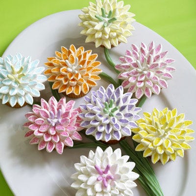 Give dessert a festive floral theme. Cut mini marshmallows on the diagonal and dip the sticky side in colored sugar to make dozens of pink, yellow, purple, blue, and orange mum petals.
  Recipe: Mum's the Word Cupcakes