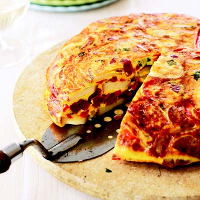 Spanish Tortilla with Chorizo and Peppers <p>After the Spanish came to the Americas, they took many things they found there back to Europe, including the potato, and started a real craze on most of the continent. The potato is still used in much of Spanish cooking, and one of the country's signature dishes, the omelet filled with tender potatoes called a tortilla, is an easy and tasty way to enjoy this now-common root vegetable.</p><p><b>Recipe: <a href="/recipefinder/spanish-tortilla-chorizo-peppers-ghk">Spanish Tortilla with Chorizo and Peppers</a></b></p>