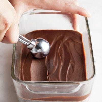 Refrigerated and firmed up, ganache has the perfect texture for rolling into truffles. The batch here was flavored with peanut butter. Adding liqueur or a flavored extract is another option, as is rolling straight-up chilled ganache. 