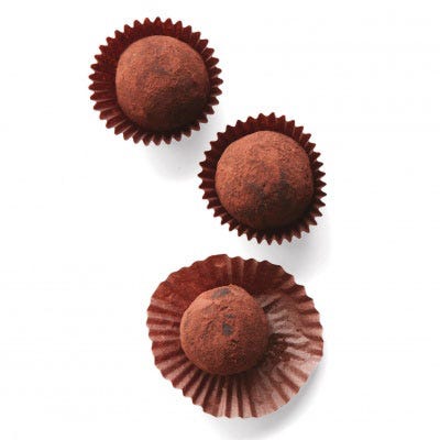 Roll each in unsweetened Dutch-process cocoa powder, tapping gently to remove excess. Refrigerate in mini baking cups for 30 minutes (or up to 4 days). 