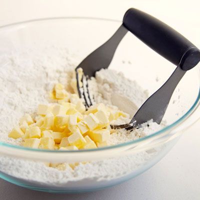 Cut the cubed butter into the flour mixture with a pastry blender, rocking the blender back and forth. Alternatively, rub the butter into the flour mixture using your fingertips.
