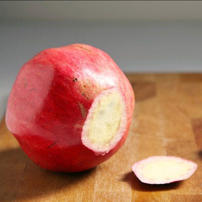 Take a shallow slice off of the stem end (bottom) of the pomegranate. Then cut out a cone-shaped piece around the blossom. Aim to remove as much of pomegranate flesh without piercing any seeds.