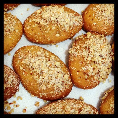 Melomakarona, Greece <p>Don't mistake these Greek sweets for run of the mill cookies, between their sticky-sweet honey glaze and dusting of walnut pieces, they'll have you licking your fingers like no cookie you've ever eaten before. An oil base means their texture are closer to cake than cookie and they're flavored with bright, seasonal splashes of orange and brandy. Hint: a cinnamon stick and a couple whole cloves thrown into the finishing syrup brings home the holidays in this recipe.</p>