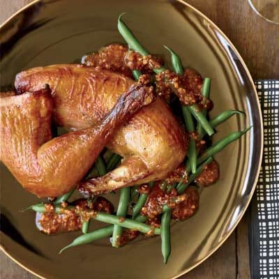 <p>Smoking the birds quickly over anise-scented tea makes them wonderfully fragrant. If you prefer to cook one chicken instead of two, smoke it in a wok or a pot rather than a roasting pan.</p>
<p><strong>Recipe: <a href="http://gogonow.org/recipefinder/tea-smoked-roast-chickens-recipe-fw0910%22 target="_blank">Tea-Smoked Roast Chickens</a></strong></p>