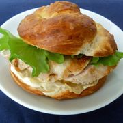 <p>Pretzel buns are a trendy way to remix your usual lunchtime sandwich.</p>
<p><em>To make:</em><br />
1. Preheat oven to 300 degrees F. On parchment-lined rimmed baking sheet, sprinkle 1/2 cup baking soda. Bake baking soda 45 minutes. Remove from oven; let cool.<br />
    2. Increase oven to 450 degrees F. In 4-quart saucepot, heat 8 cups water until hot; whisk in baked baking soda (try to avoid touching the baked baking soda, as it could irritate your skin). Line baking sheet with new sheet parchment.<br />
    3. Roll and stretch a large handful of dough into 12-inch-long rope. Twist ends and press ends into center of rope to form fat pretzel shape. Repeat with remaining dough.<br />
    4. Gently lower into hot water as many pretzels as will comfortably fit into pot. Let soak for 30 seconds, flipping occasionally. Remove pretzels with large slotted spoon and place on parchment-lined baking sheet. Repeat with remaining pretzels.<br />
   5. Brush tops of soaked pretzels with beaten egg yolk and sprinkle with coarse sea salt. Bake 15 to 20 minutes or until very dark brown. Slice in half and use for chicken sandwiches or burgers.
</p>