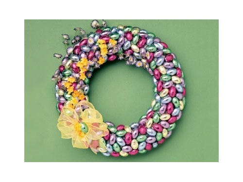 Greet your guests in style with this shiny door decoration. Keep things cheery by using lots of different-colored foil-wrapped candies, but stick to a pattern to please eyes.
<br /><br />
Get the instructions at <a href="https://www.hersheys.com/celebrate/easter/craftdetail.aspx?id=20" target="_blank">Hershey’s</a>
