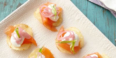 <p>These small bites are big on flavor: crunchy potato chips are topped with smoked salmon, sour cream, pickled shallots, and fresh tarragon. This effortless appetizer is sure to impress.</p><p><strong>Recipe:</strong> <a href="http://www.delish.com/recipefinder/smoked-salmon-bites-recipe-ghk0414"><strong>Smoked Salmon Bites</strong></a></p>