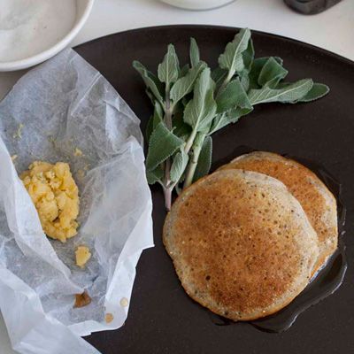 <p>To create these pancakes, chefs Daniel Patterson and René Redzepi started with a standard cornmeal pancake recipe they found online. They added rice flour to make the pancakes light and served them with brown butter studded with bits of fresh lemon and sage. Like all good pancakes, they're served with warm maple syrup, too.</p>