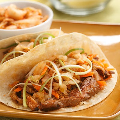 <p>The spicy, pickled flavor and crunchy texture of kimchi, the Korean cousin to sauerkraut, is just right on these Korean steak-and-mushroom tacos. Serve with steamed brown rice and sautéed bok choy with chile-garlic sauce.</p>
<p><strong>Recipe:</strong> <a href="http://gogonow.org/recipefinder/korean-steak-mushroom-tacos-kimchi-recipe-ew0811%22 target="_blank"><strong>Korean Steak and Mushroom Tacos with Kimchi</strong></a></p>

