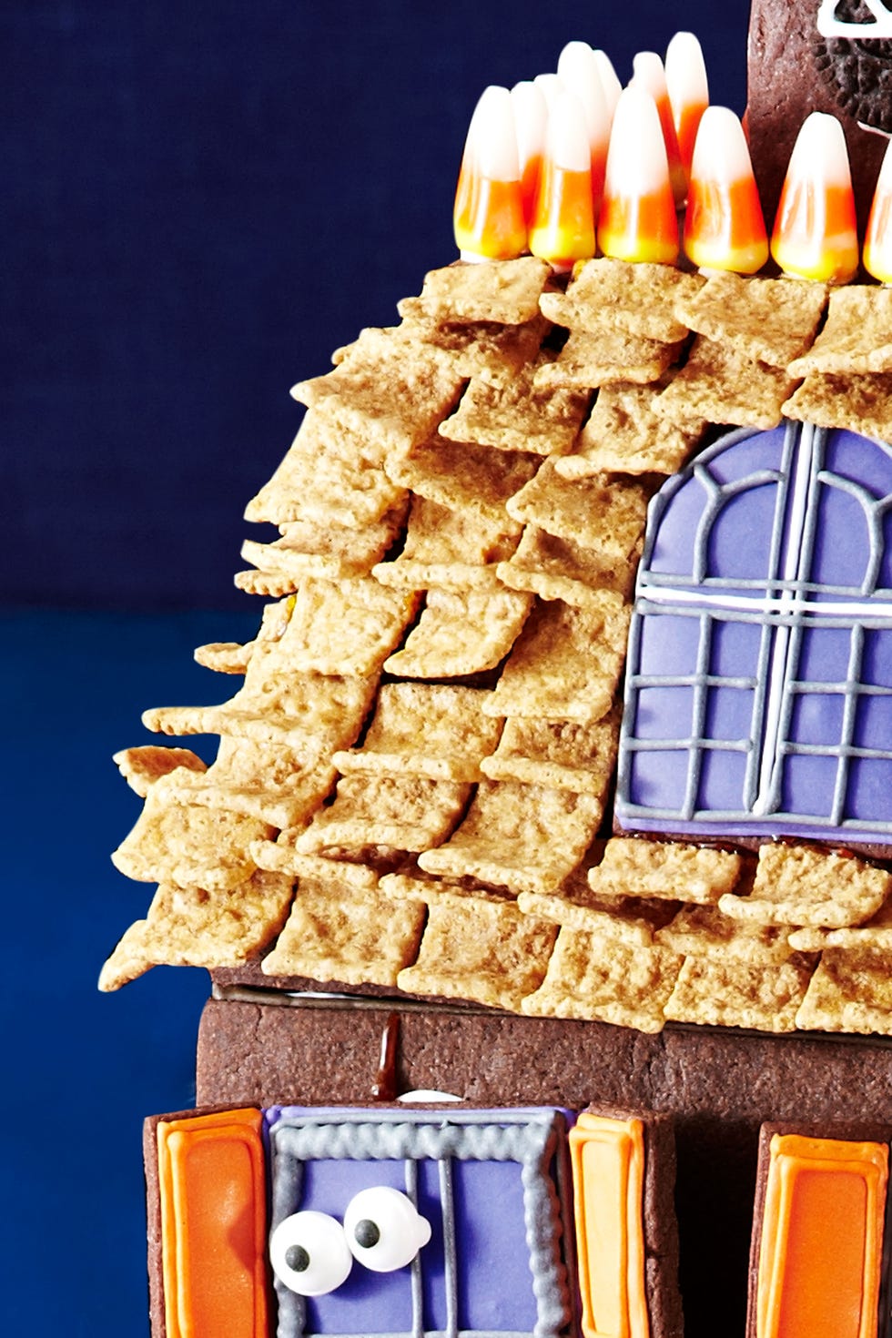 <p>Starting with the top row, stick Golden Graham Cereal shingles on the roof using melted hard caramel.</p>
<p><a href="http://www.womansday.com/food-recipes/holiday-recipes/halloween-haunted-house" target="_self">Watch this video to see how to attach the shingles.</a></p>