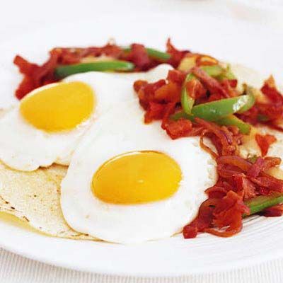 <p>Sunny side up eggs welcome a warm, peppery tomato salsa in this version of a Mexican favorite.</p><br /><p><b>Recipe: </b><a href="/recipefinder/huevos-rancheros-spicy-ham-sofrito-recipe-7934" target="_blank"><b>Huevos Rancheros with Spicy Ham Sofrito</b></a></p>