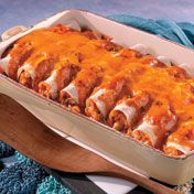 Cubed chicken and shredded cheese are rolled up in corn tortillas, then baked in a Southwestern-inspired creamy tomato sauce