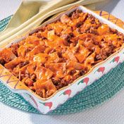 This fabulous skillet dish is perfect for a busy family.  It features tortillas and ground beef  layered with cheese and a mildly spicy tomato sauce, then baked until bubbling.
