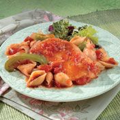 Chicken stock is the secret to creating a simmering tomato sauce that seasons the chicken, vegetables and pasta shells in this flavorful skillet supper.