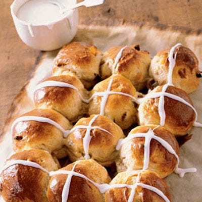 This seasonal British specialty, known for its raisins, candied citrus peel, and crosses of sweet white icing, has long delighted families come Easter morning.