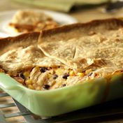 This crowd-pleasing, kicked-up casserole uses pantry ingredients and refrigerator staples topped with a refrigerated pie crust and baked until the filling is bubbling and the crust is golden.