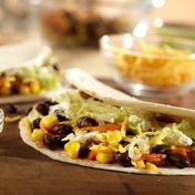 Soft tortillas are filled with a colorful combination of sautéed carrot, black beans and corn enhanced with chili powder and Pace{{{reg}}} Picante Sauce.