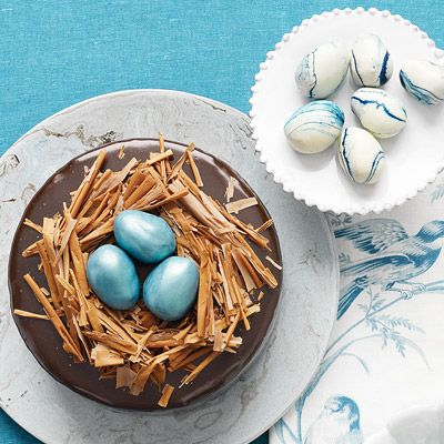 <p>Tucked inside nests of milk-chocolate shavings are truffle eggs tinted robin's egg blue and dusted with metallic luster. The accompanying marbled eggs are created by dipping more truffles into melted white chocolate swirled with blue food coloring.</p><br /><p><b>Recipe: <a href="/recipefinder/chocolate-cake-ganache-frosting-truffle-recipe" target="_blank">Rich Chocolate Cake with Ganache Frosting and Truffle-Egg Nest</a> </b></p>