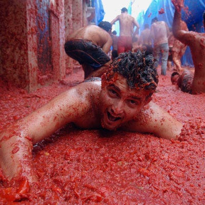 What's rumored to have originated as a local brawl (possibly an attack on city council members by disgruntled townspeople) in Buñol, Spain, has turned into the world's largest food fight, with some 45,000 revelers hurling more than 250,000 pounds of tomatoes at one another the last Wednesday in August.<br /><br />Prefer to eat your tomatoes? Try one of these <a href="/recipes/cooking-recipes/easy-30-minute-tomato-recipes" target="_blank">30-minute tomato recipes</a>.