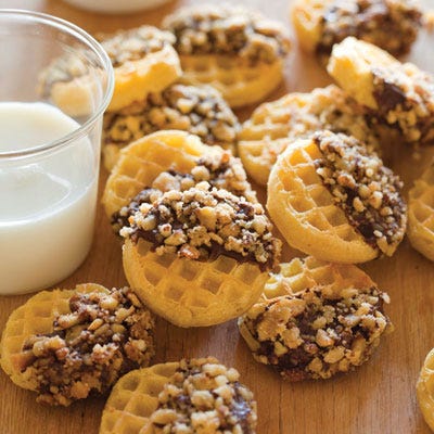 Fudge puppies are a traditional fair food: toasty waffles dipped in chocolate and topped with whipped cream, crushed nuts, or other toppings. <p><p><b>Recipe: <a href="http://gogonow.org/recipefinder/little-bitty-fudge-puppies-recipe-del1012%22 target="_blank">Little-Bitty Fudge Puppies</a></b>
