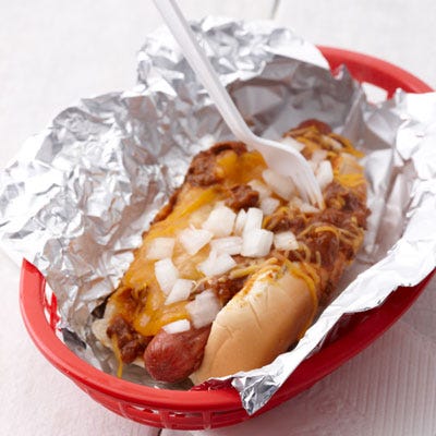 Cincinnati Reds Cheese Coney <p><b>Stadium:</b> <a href="http://cincinnati.reds.mlb.com/cin/ballpark/index.jsp"target="_blank">Great American Ball Park</a></p>
<p><b>Why It's a Hit:</b> Skyline Chili. Cincy residents are as passionate about their Reds as they are about their chili. Cloaked in the famous Skyline saucy chili with hints of cinnamon and chocolate, the Cheese Coney is then topped with chopped onions and heaps of tangy, shredded cheddar cheese.</p>