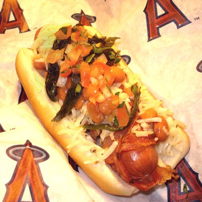 Los Angeles Angels Halo Dog <p><b>Stadium:</b> <a href="http://losangeles.angels.mlb.com/ana/ballpark/index.jsp"target="_blank">Angels Stadium, Anaheim, CA</a></p>
<p><b>Why It's a Hit:</b> Bacon. Followers of the Mexican-style street dog will be happy to find it at Angels Stadium. The all-beef hot dog is wrapped with bacon and topped with charro beans, shredded Monterey Jack cheese, and pico de gallo salsa.</p>