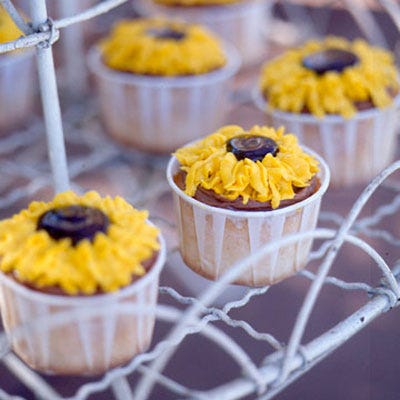 Top cupcakes with cheery sunflowers by piping yellow-tinted frosting into petal shapes. Use fudge ice cream topping for the center of each flower.<br /><br /><b>Recipe: <a href="/recipefinder/sunflower-cupcakes-recipe" target="_blank">Sunflower Cupcakes</a></b>
