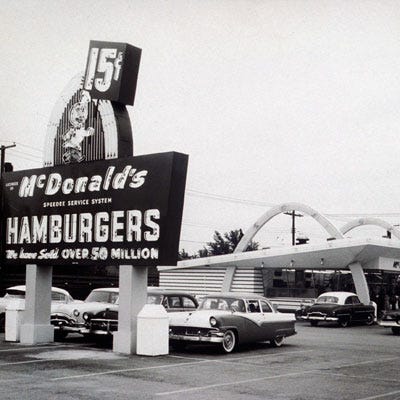 <p><b>Year Opened:</b>1940 </p>
<p><b>First Location:</b> San Bernadino,  CA</p>
<p><b>Bite of History:</b>  Dick and Mac McDonald started McDonald's as a very different concept. Instead of hamburgers, the brothers created a drive-in restaurant with a comprehensive barbecue menu. They soon scrapped that idea in favor of a 9-item menu: hamburger, cheeseburger, three soft drinks, milk, coffee, potato chips, pie, French fries, and milkshakes. By 1952, word of their success (and a cover story in <i>Restaurant Magazine</i>) traveled as far as Arizona, where they allowed Neil Fox to launch a carbon copy restaurant with the signature golden arches. Three years later, Ray Kroc, a "Multimixers" milkshake machine salesman, took the reigns as official franchising agent. On April 15, 1955, the first franchise opened in Des Plaines, IL, selling fries for 10 cents and burgers for 15 cents. </p> 
